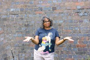 Woman in blue T-shirt with an open hand gesture 